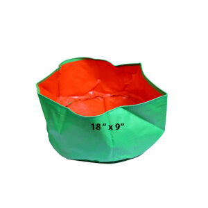 A wide 18 x 9 Inch Premium HDPE Grow Bag in green and orange, ideal for growing ginger and turmeric on a terrace garden.