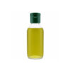 Premium glass bottle of Nativus Farms wood pressed almond oil resting on a minimalist wooden surface with whole almonds.